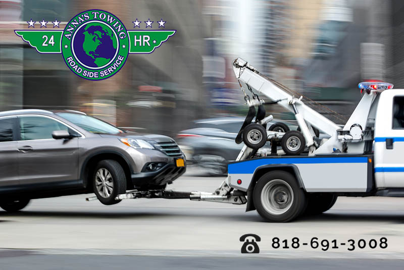 A-Reseda-Towing-Service-Can-Keep-You-Safe A tow truck towing a car on the street