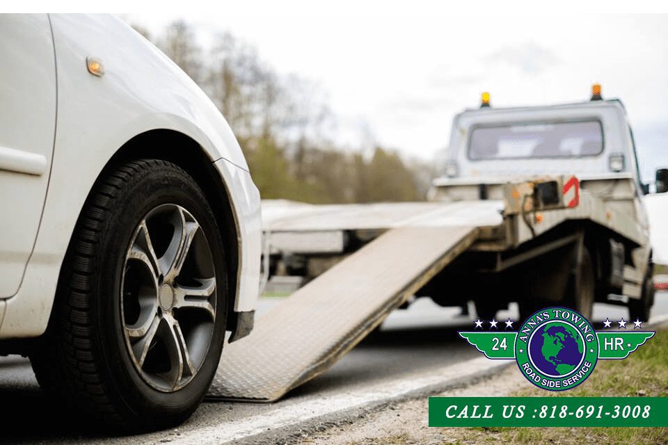 Be-Ready-For-Any-Emergency-with-Our-Reseda-Towing-Number A white car is being towed by a tow truck.