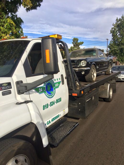Finding-Towing-Services-in-Sunset-Blvd A tow truck towing a car on the road