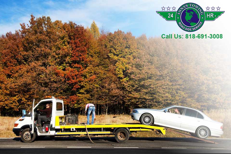 Santa-Clarita-Towing Tow truck with car in autumn setting.