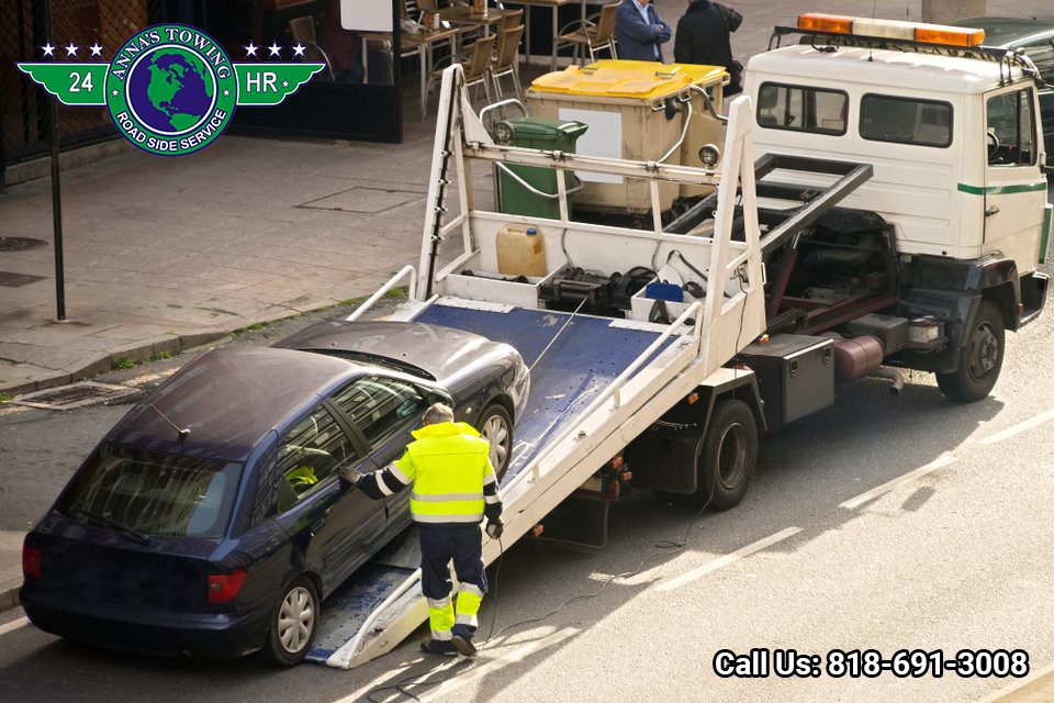 West-Hollywood-Towing-Service-for-Any-Roadside-Assistance-You-Need Tow truck loading a car onto flatbed.