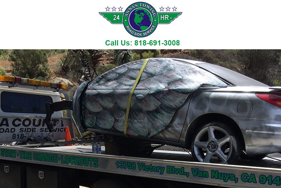 Will-Santa-Clarita-Towing Car towed on flatbed truck, roadside service.