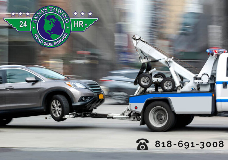 A-Reseda-Towing-Service-Can-Keep-You-Safe A tow truck towing a car on the street