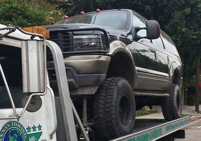 How-to-Find-Local-Towing-Near-Me A truck is being towed by a tow truck.