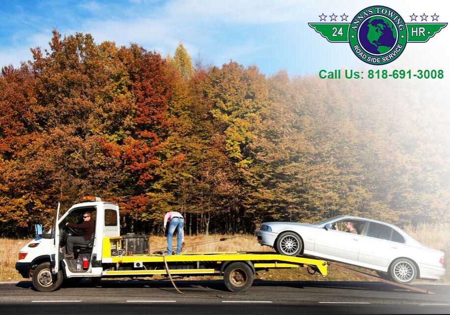 Santa-Clarita-Towing Tow truck with car in autumn setting.
