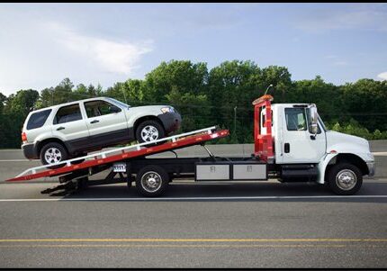 towing-northridge A tow truck is carrying a car on the road.